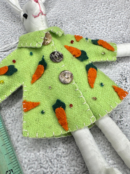White bunny with green carrot coat