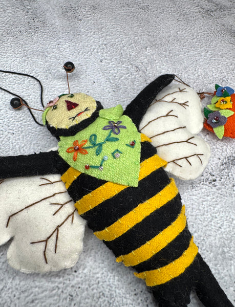 Primitive bee with flower basket