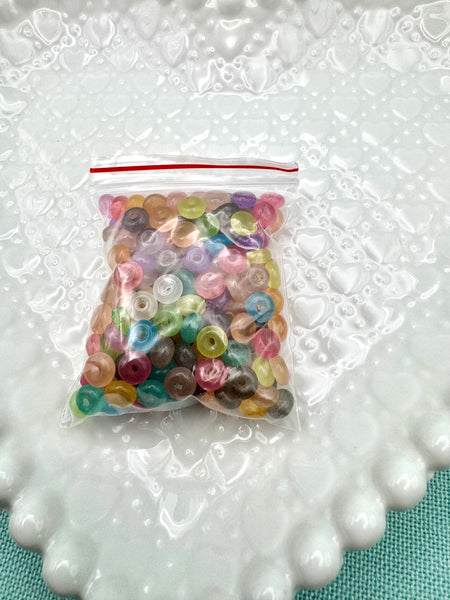 Clear, colored 6mm donut glass beads