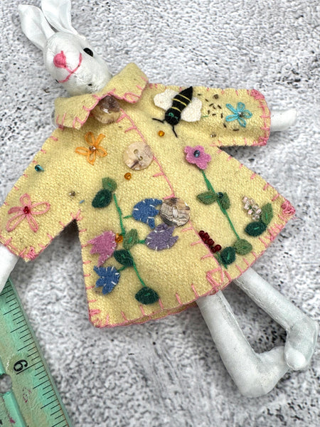White bunny in yellow coat